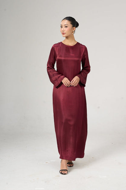 Model wearing the Celeste bordeaux rose hand-dyed silk maxi dress with flared sleeves