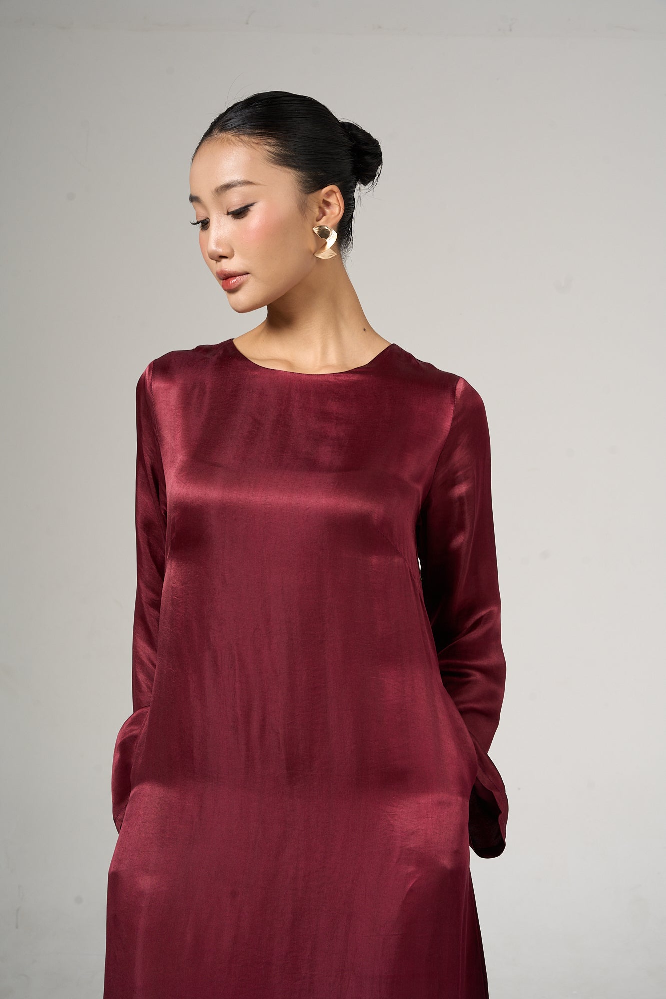 Celeste bordeaux rose silk maxi dress with flared sleeves, shown from the side