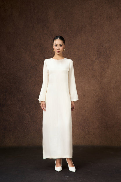 Celeste ivory pearl silk maxi dress with flared sleeves, shown from the side