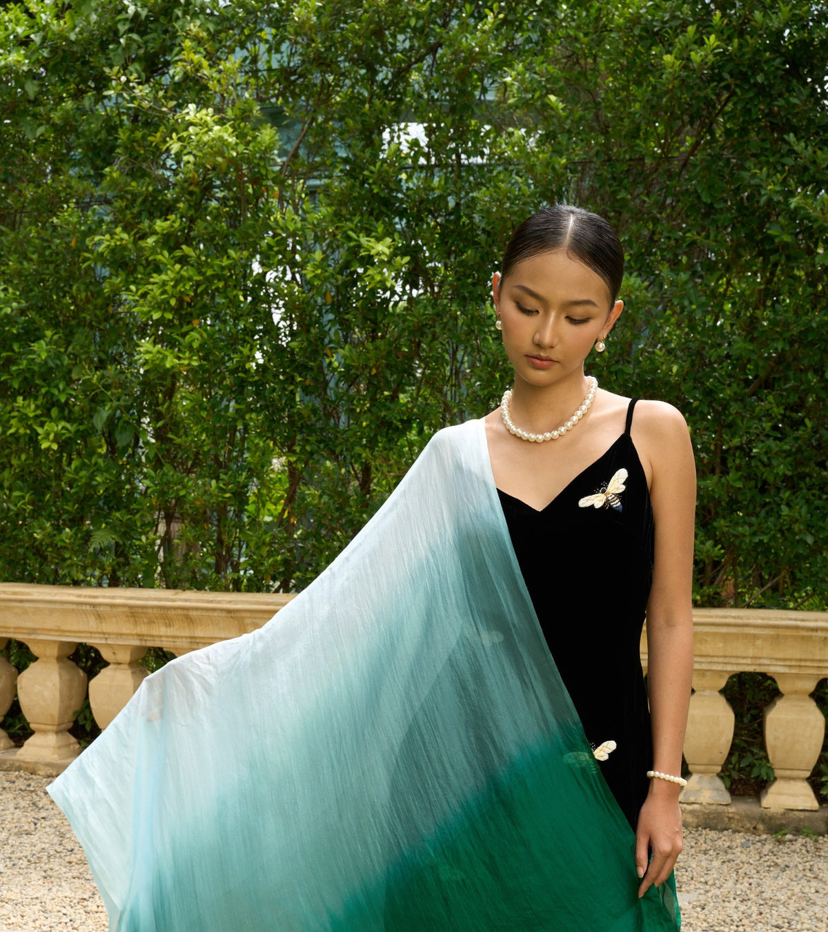 Model draped in a hand-dyed emerald ombré mulberry silk shawl