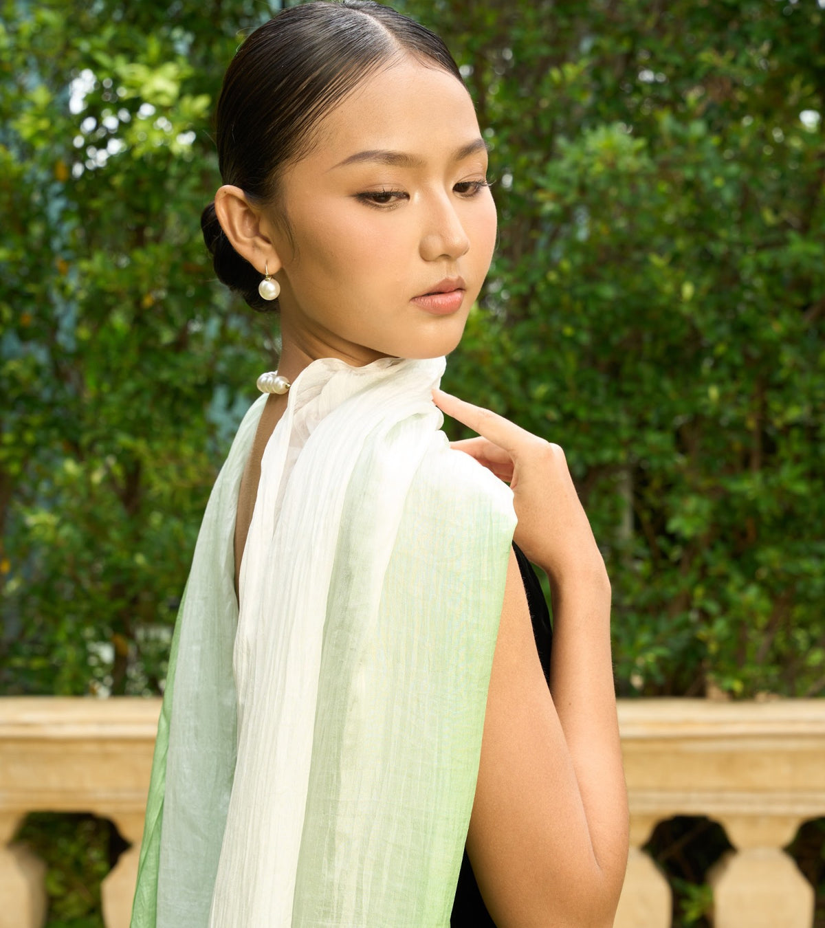 Model wrapped in a hand-dyed ivory and mint ombré silk shawl